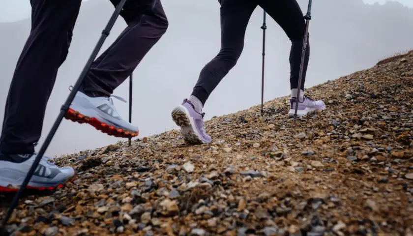 Randonneurs en montée, leurs chaussures de trail avec semelle de propreté assurant l'adhérence sur terrain rocailleux.